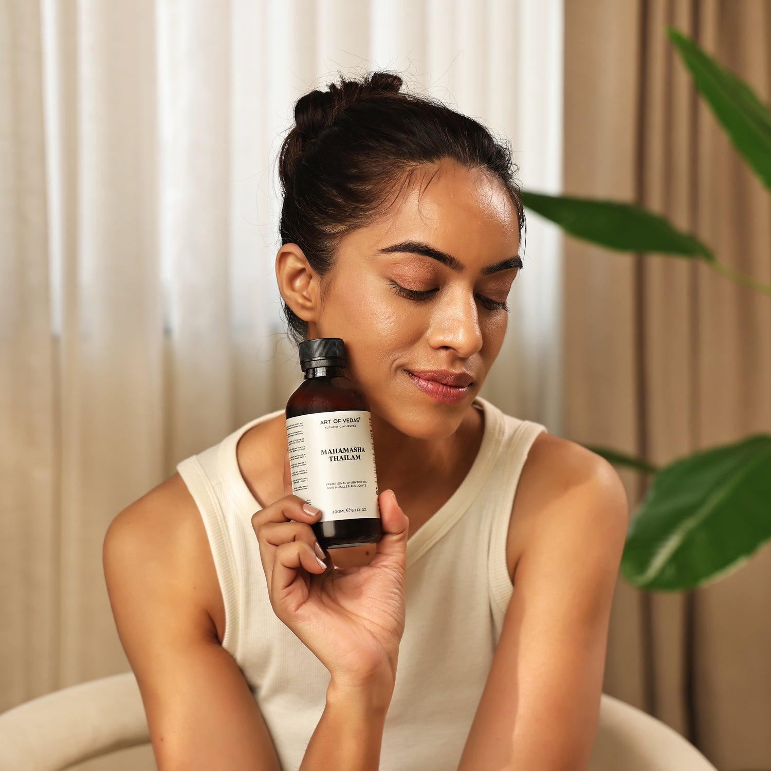 Art of Vedas Mahamasha Thailam Ayurveda Oil - Woman Holding Ayurvedic Oil for Muscle Strength and Nerve Support